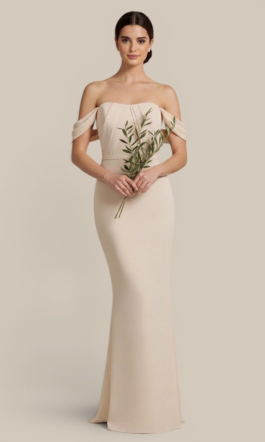 Classic elegant bridesmaid wearing an ivory boutique chiffon bridesmaid dress, holding olive foliage to complement the sage and pastel wedding palette.