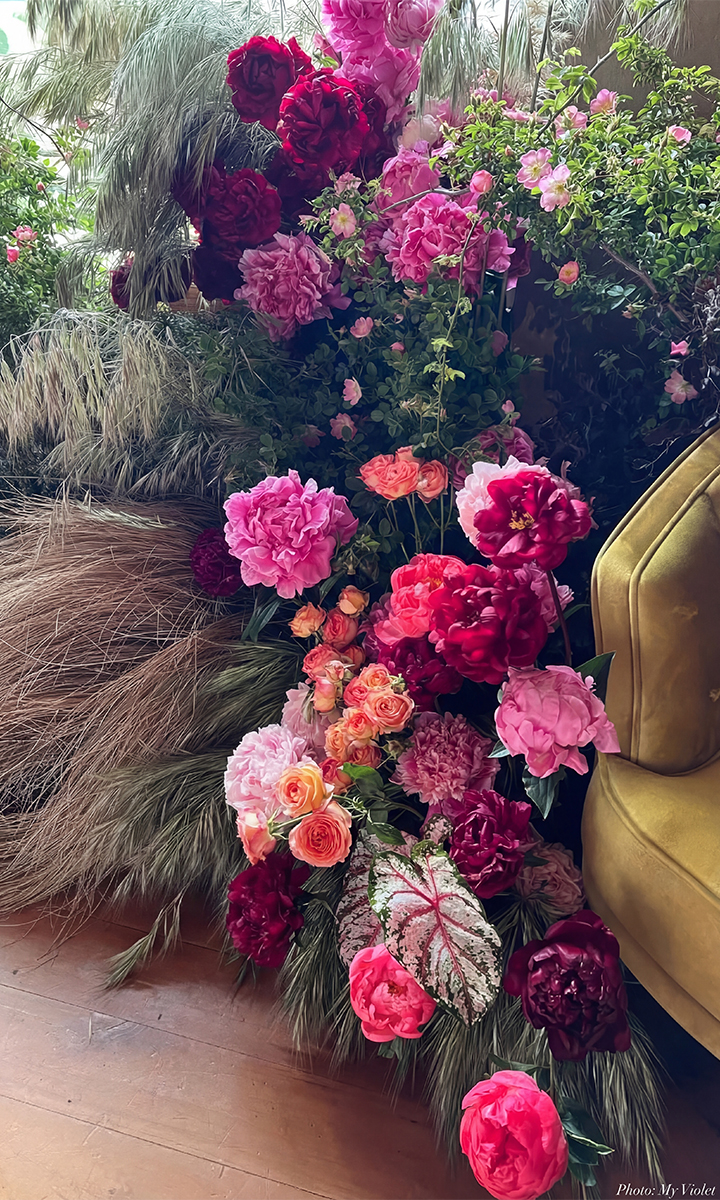 Stunning wedding floral arrangement, featuring vibrant coral, dark pink and berry pink blooms, perfectly designed to match and elevate our mix and match bridesmaid dress collections.