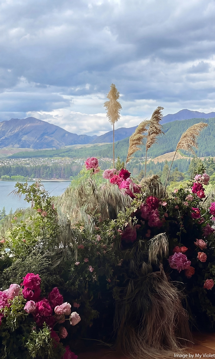 A romantic wedding flower arrangement in rich dark pink berry and soft pink shades, providing effortless styling inspiration to perfectly complement our boutique bridesmaid dresses.