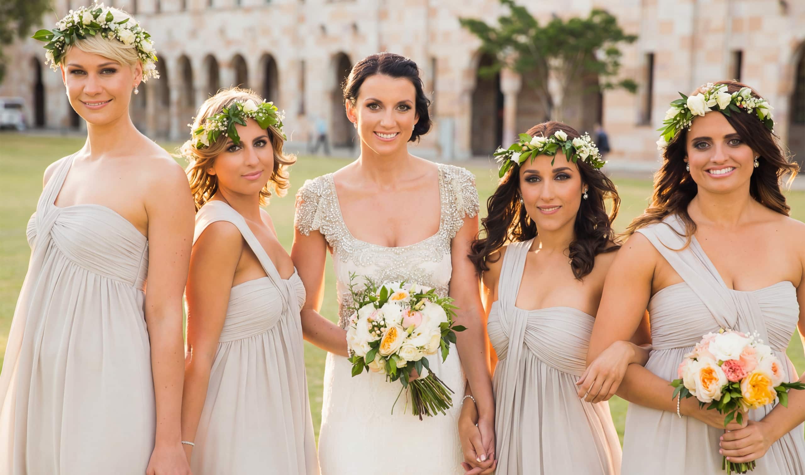 real-wedding-grey-chiffon-boutique-bridesmaid-dresses A beautiful bride standing with her four bridesmaids, who are wearing flawlessly styled and matched elegant grey chiffon boutique bridesmaid dresses and holding stunning wedding bouquets.