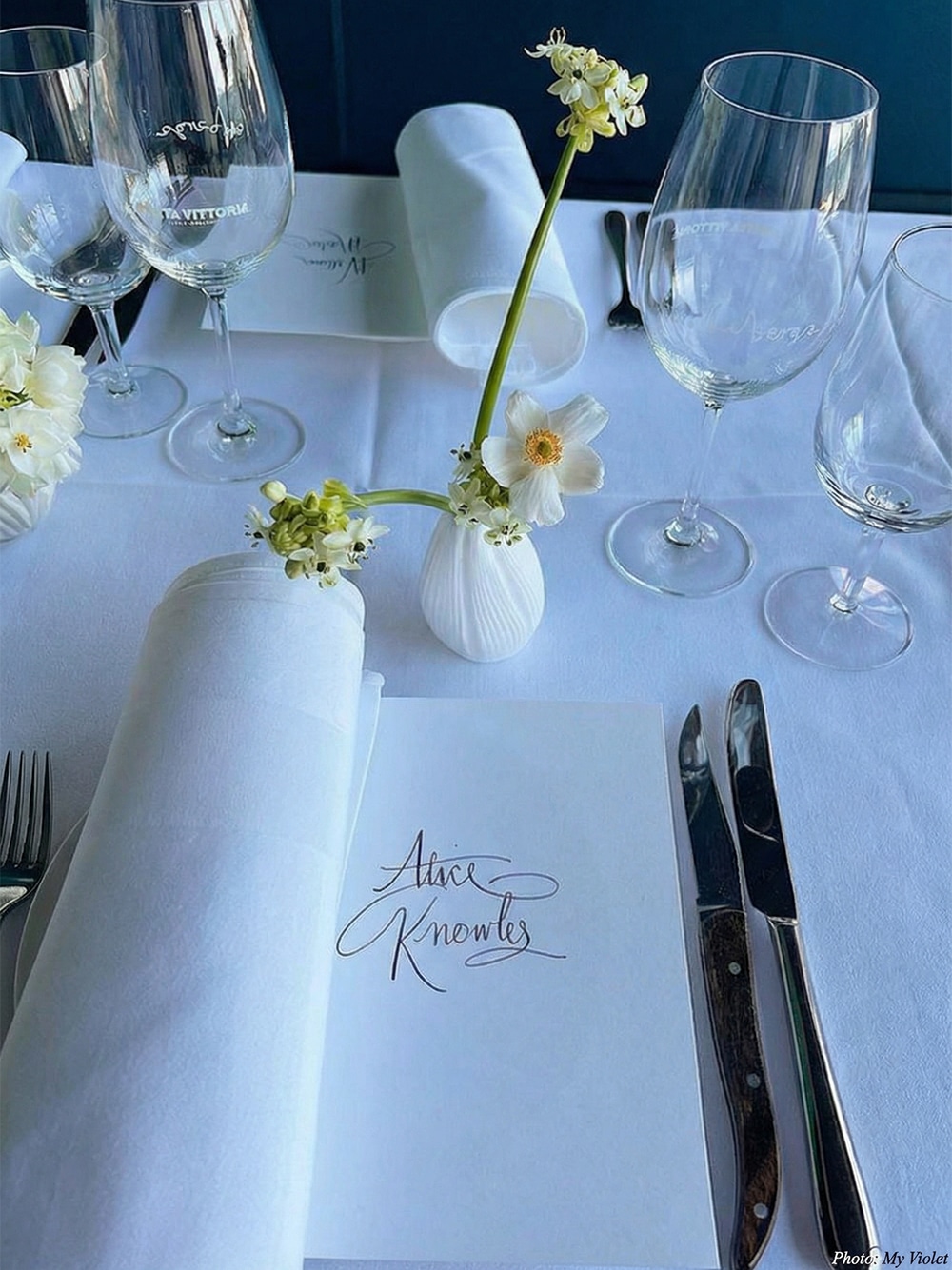 A romantic wedding table setting featuring delicate floral arrangements, perfectly curated to complement our sage and pastel boutique bridesmaid dresses.
