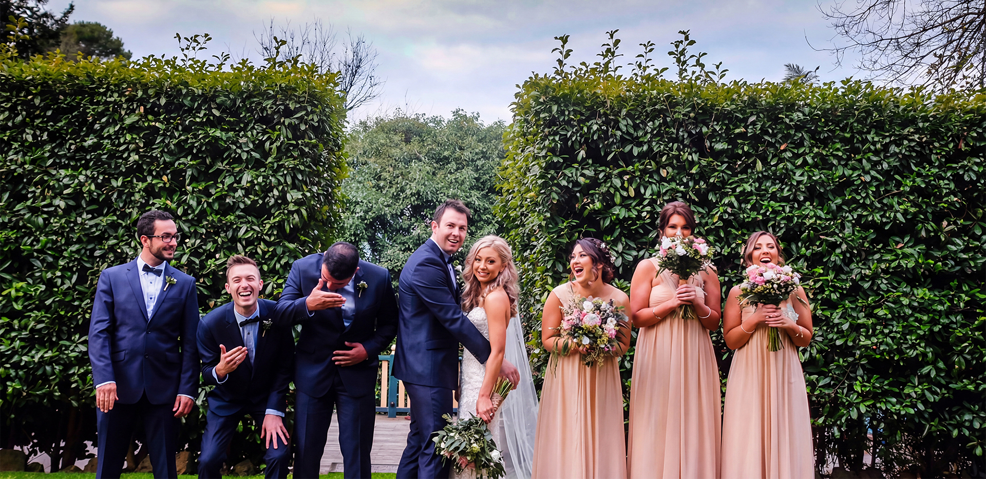 beige-chiffon-one-shoulder-bridesmaid-dresses-real-wedding Bridal party featuring three bridesmaids wearing elegant beige chiffon one shoulder bridesmaid dresses by Natasha Millani.