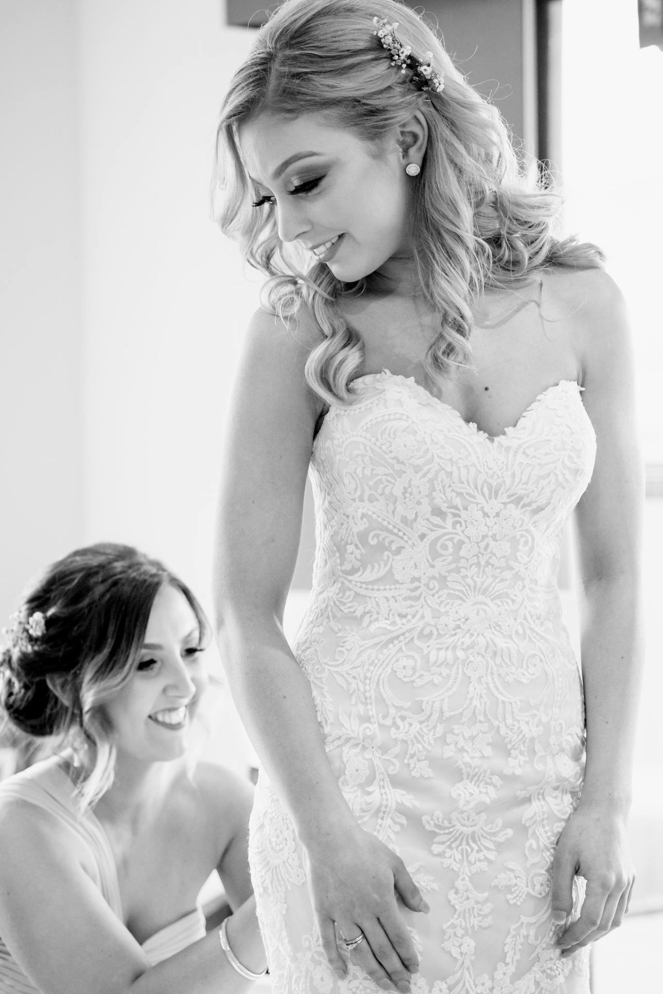 bride-and-bridesmaid-wedding-reception-prep Black and white photo of the bride and her bridesmaid preparing for the wedding reception.