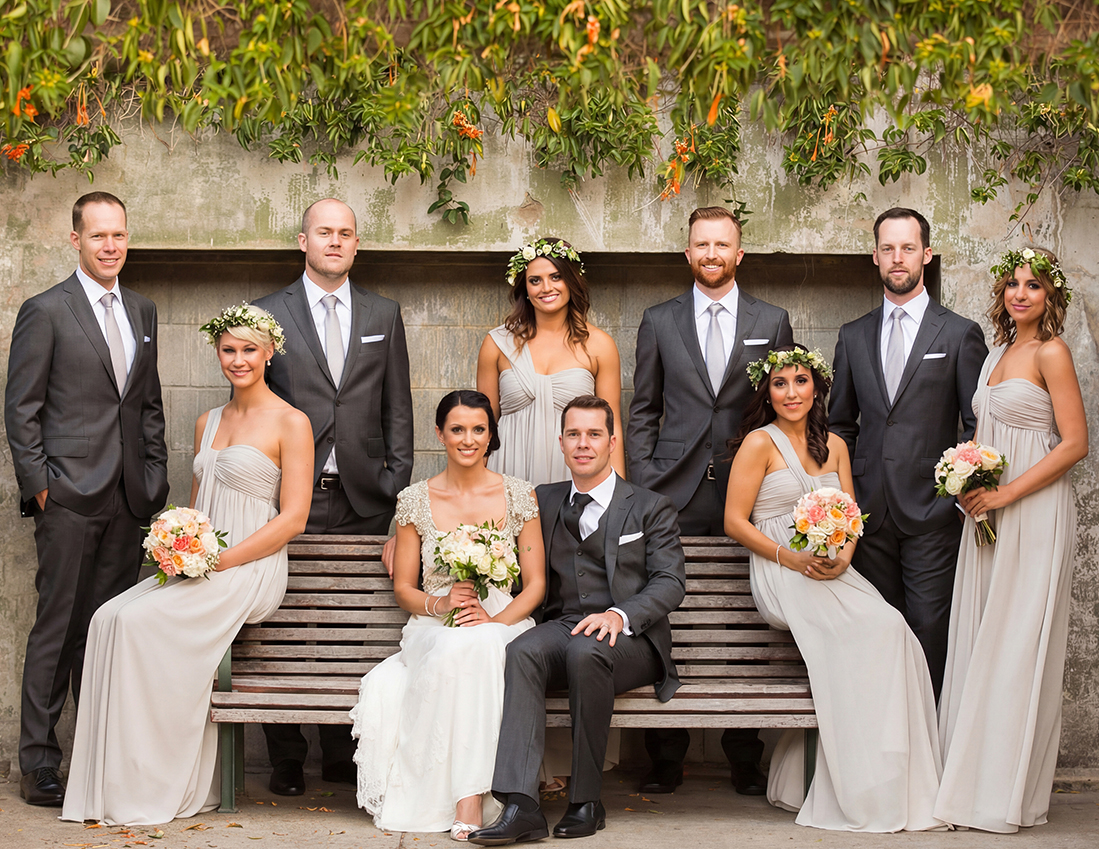 Bridal party featuring four bridesmaids in grey one-shoulder chiffon dresses by Natasha Millani.