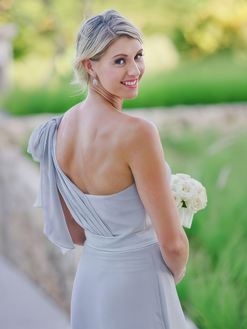 Stunning garden wedding aisle flower arrangements, curated to compliment mix and match pastel bridesmaid dresses.