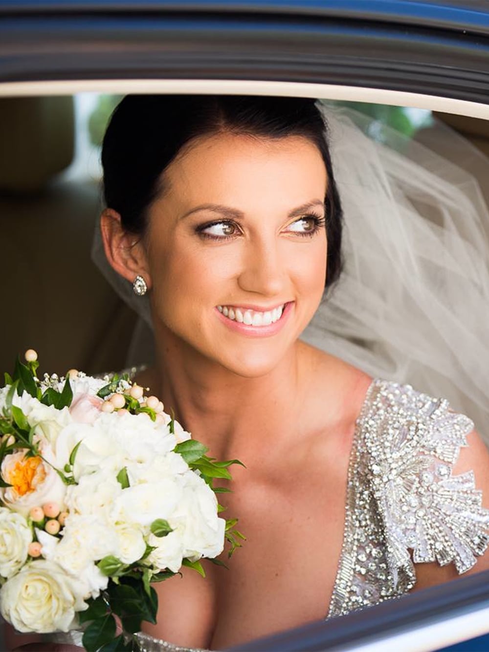 Classic portrait of the bride arriving in a wedding car.