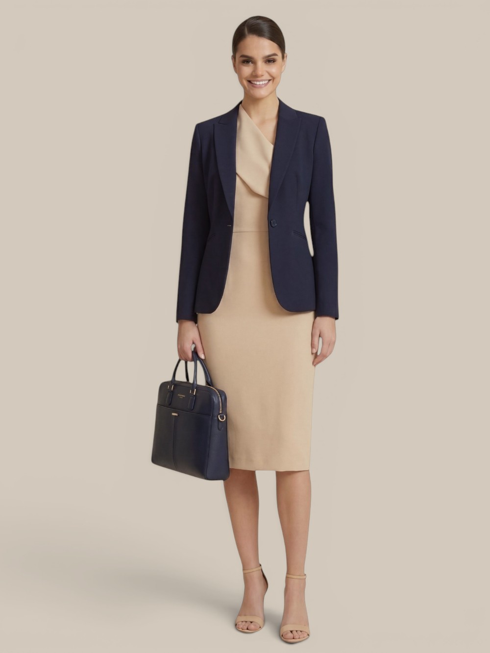 beige-chiffon-cocktail-office-dress-styled-with-blazer A sophisticated woman wearing a tailored beige chiffon cocktail dress (which is our altered bridesmaid dress) with a structured navy blue blazer and business handbag. Another example how bridesmaids can wear our versatile designs again to office functions and formal events.