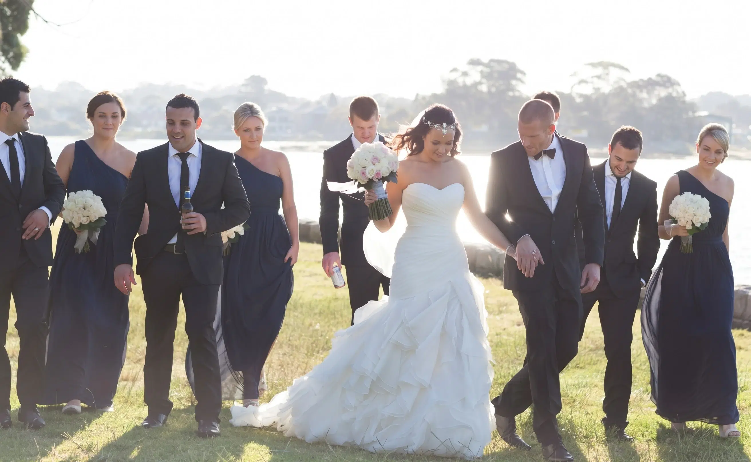 Beautiful Real Bride and her bridesmaids in one shoulder chiffon navy bridesmaid dresses by Natasha Millani.